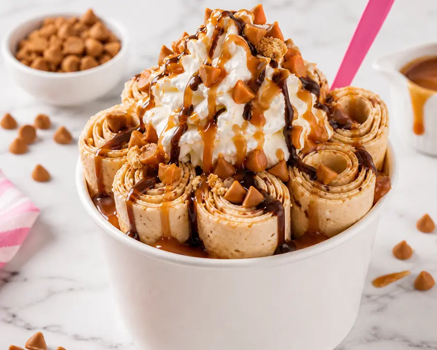 Butterscotch rolled ice cream with caramel and chocolate drizzle