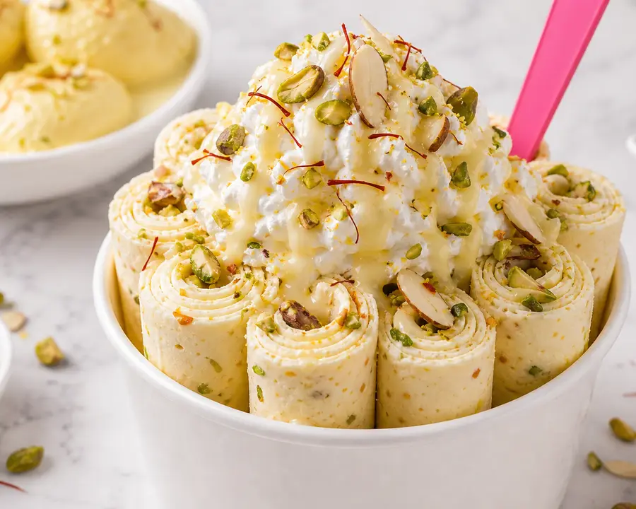Ras Malai rolled ice cream with saffron, pistachio, almond slivers, and condensed milk